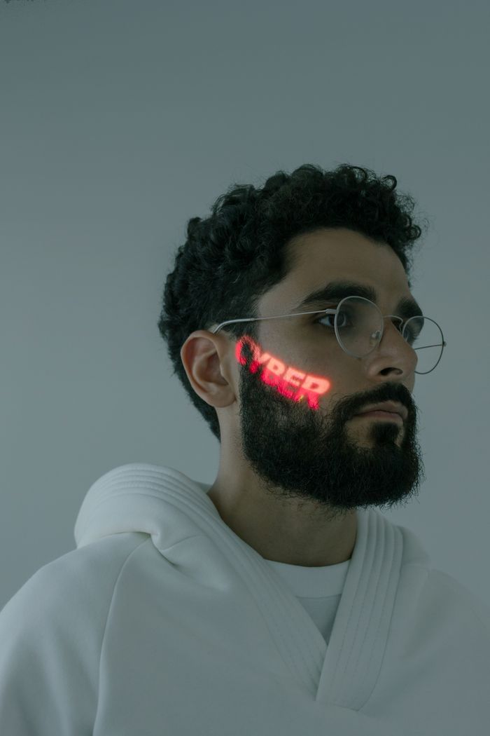 Services Stylish man with CYBER projection on face wearing eyeglasses, futuristic tech vibe.